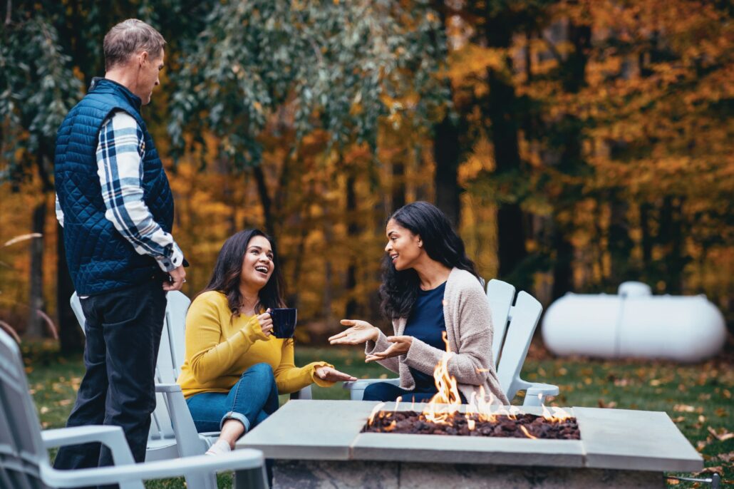 people-conversing-around-the-fire-pit-and-propane-tank-web-1030x686