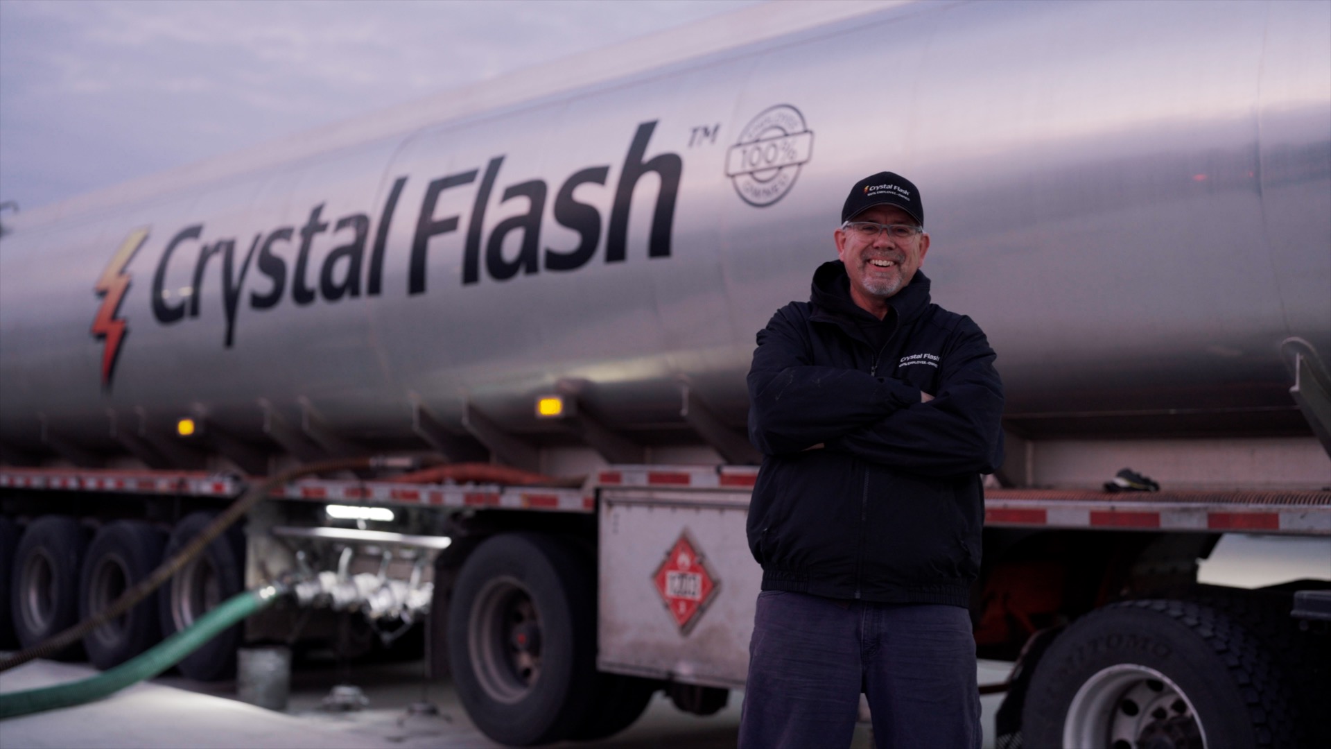 Crystal Flash employee standing in front of a transport truck