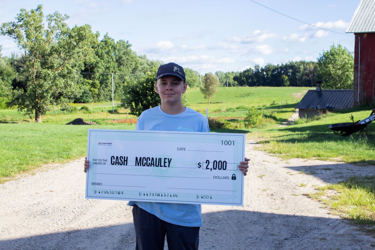 Cash McCauley holding Growing Forward Award Check