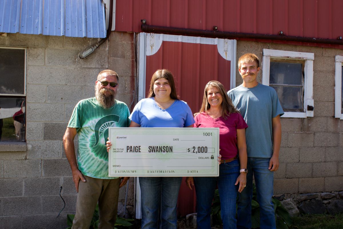 Paige Swanson and family holding Growing Forward Award Check